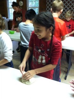 Melanie is folding and shaping her loaf of bread. (And in the background you can see Lauren helping Nicholas.)